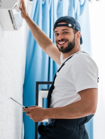 smiling-workman-looking-at-camera-while-repairing-2021-09-21-23-34-35-utc-1-1-qazfqum6bnhf40togzu3vozm6rli0s5a86vfmxes2c